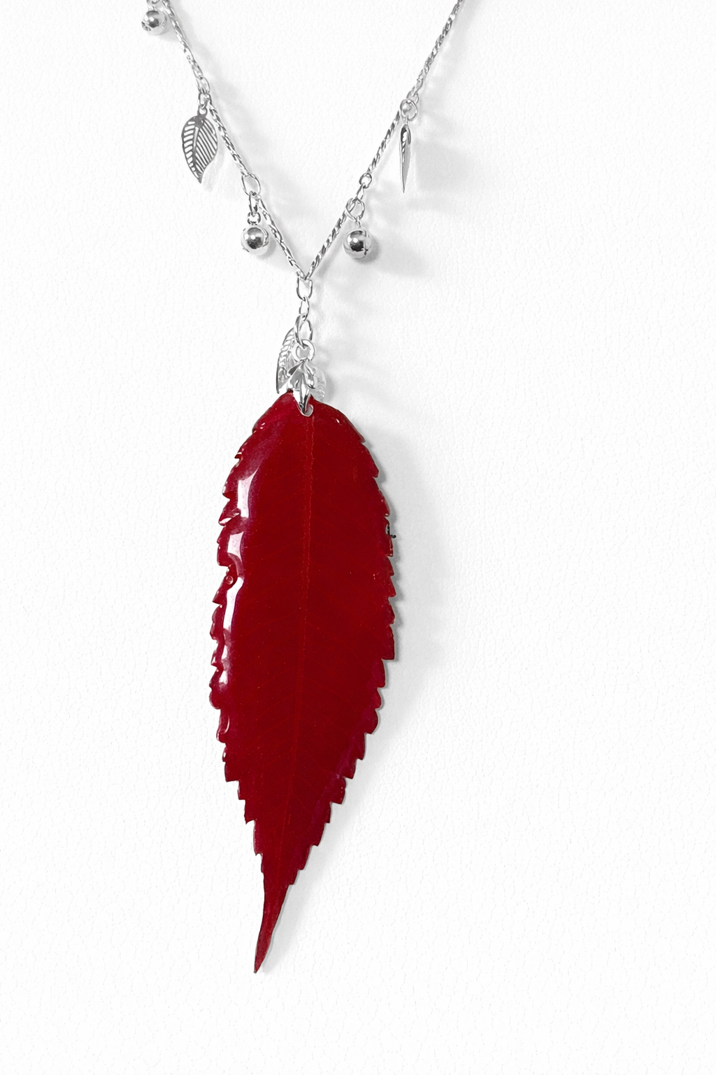 Red leaf pendant on silver chain